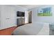 Serene bedroom with a built-in TV stand and hardwood floors at 138 Wyanoke Ave, Charlotte, NC 28205