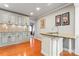 Updated kitchen featuring an island with a sink, granite countertops, mosaic backsplash, and cabinetry with modern hardware at 138 Wyanoke Ave, Charlotte, NC 28205