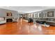 Open-concept living room with fireplace, hardwood floors, ample seating, and a view into the kitchen and dining area at 138 Wyanoke Ave, Charlotte, NC 28205