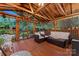 Cozy screened porch with wooden deck, wicker furniture, and outdoor lighting at 138 Wyanoke Ave, Charlotte, NC 28205