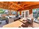 Spacious screened porch with wooden deck, wicker furniture, and ceiling fan at 138 Wyanoke Ave, Charlotte, NC 28205