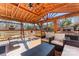 Relaxing screened porch with wooden ceiling, wicker furniture, and a built-in grill at 138 Wyanoke Ave, Charlotte, NC 28205