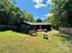 Spacious backyard with a wooden deck, mature trees, and a privacy fence perfect for entertaining at 3452 Airlie St, Charlotte, NC 28205