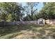 Spacious backyard with privacy fence, mature trees, green grass, and storage shed at 3452 Airlie St, Charlotte, NC 28205