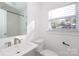 Bright bathroom with a sink, toilet and tub with shower at 3452 Airlie St, Charlotte, NC 28205