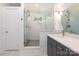 Bright bathroom featuring vanity with gray cabinets, a walk-in shower, and marble floors at 3452 Airlie St, Charlotte, NC 28205