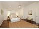 Bedroom with vaulted ceiling, hardwood floors, bench seating, and neutral paint at 3452 Airlie St, Charlotte, NC 28205