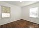 Bright bedroom with hardwood floors, two windows, and natural light at 3452 Airlie St, Charlotte, NC 28205