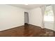 Spacious bedroom with hardwood floors, a window, and a closet at 3452 Airlie St, Charlotte, NC 28205