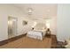 Bedroom with vaulted ceiling, hardwood floors, neutral decor, and ensuite bathroom at 3452 Airlie St, Charlotte, NC 28205