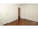 Clean bedroom boasts shiny hardwood floors, white walls and doors, and natural light at 3452 Airlie St, Charlotte, NC 28205