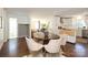Open-concept dining area with hardwood floors connected to the living room and kitchen at 3452 Airlie St, Charlotte, NC 28205