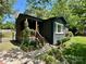 Charming home with a welcoming porch and landscaped front yard featuring rocks and healthy shrubbery at 3452 Airlie St, Charlotte, NC 28205
