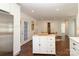 Bright kitchen features a center island, stainless appliances, white cabinets, and hardwood floors at 3452 Airlie St, Charlotte, NC 28205