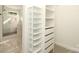 Organized walk-in closet with shelving, drawers, and ample storage space, bathroom in background at 3452 Airlie St, Charlotte, NC 28205