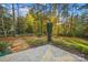 Secluded backyard with lush foliage, patio, and distant firepit creating a peaceful outdoor oasis at 6003 Hawk View Rd, Waxhaw, NC 28173