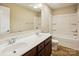 Bathroom features double vanity, wood cabinets, and shower with tub at 6003 Hawk View Rd, Waxhaw, NC 28173