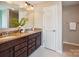 Bathroom with double sink vanity, granite countertops, and dark wood cabinets at 6003 Hawk View Rd, Waxhaw, NC 28173