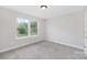 Neutral bedroom with soft carpet, natural light from double windows and minimalist design at 6003 Hawk View Rd, Waxhaw, NC 28173
