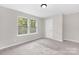 Neutral bedroom featuring two large windows for ample natural light at 6003 Hawk View Rd, Waxhaw, NC 28173