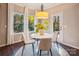 Bright breakfast nook features a modern light fixture, round table, and views of the outdoors at 6003 Hawk View Rd, Waxhaw, NC 28173