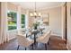Elegant dining room with modern lighting, neutral walls, and a large window with natural light at 6003 Hawk View Rd, Waxhaw, NC 28173
