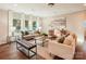 Spacious living room with large windows, comfortable seating, stylish decor, and dark hardwood floors at 6003 Hawk View Rd, Waxhaw, NC 28173