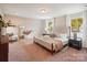 Bright and airy main bedroom with plush carpeting, natural light, and elegant furnishings at 6003 Hawk View Rd, Waxhaw, NC 28173