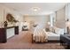Spacious main bedroom with plenty of light, neutral colors, carpet, and a console table at 6003 Hawk View Rd, Waxhaw, NC 28173