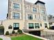 Beautiful multi-story building facade with stone and brick and manicured landscaping at 1168 Queens Rd, Charlotte, NC 28207