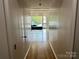 Bright hallway with wood floors, white doors, and serene views outside at 1168 Queens Rd, Charlotte, NC 28207