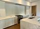 Well-lit kitchen with stainless steel appliances, light cabinets, and stone countertops at 1168 Queens Rd, Charlotte, NC 28207