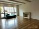 Cozy living room featuring hardwood floors, fireplace, and window seating at 1168 Queens Rd, Charlotte, NC 28207