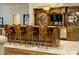 Elegant basement bar with detailed woodwork and built-in shelving at 16908 Ashton Oaks Dr, Charlotte, NC 28278