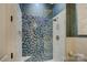 Stylish bathroom with blue and gray mosaic tile shower at 16908 Ashton Oaks Dr, Charlotte, NC 28278