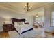 Elegant Primary bedroom with a large bed, sitting area, and hardwood floors at 16908 Ashton Oaks Dr, Charlotte, NC 28278