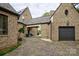 Stone courtyard with double garage and seating area at 16908 Ashton Oaks Dr, Charlotte, NC 28278