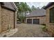 Charming courtyard with brick pavers, double garage, and tranquil fountain at 16908 Ashton Oaks Dr, Charlotte, NC 28278