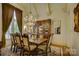 Formal dining room with a large table, chandelier, and rich wood tones at 16908 Ashton Oaks Dr, Charlotte, NC 28278