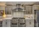 Gourmet kitchen with double ovens and a stainless steel range hood at 16908 Ashton Oaks Dr, Charlotte, NC 28278