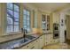 Elegant kitchen with double sinks, granite countertops, and ample cabinet space at 16908 Ashton Oaks Dr, Charlotte, NC 28278