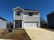 Charming two-story home with a two-car garage and neutral siding, showcasing a well-manicured lawn at 209 Alden Ct, Shelby, NC 28152