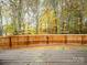 Deck overlooking a fenced backyard with wooded area at 216 Devon Forest Dr, Mooresville, NC 28115