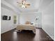 Bright bedroom with a queen-size bed and dark hardwood floors at 216 Devon Forest Dr, Mooresville, NC 28115