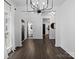 Bright dining room with dark hardwood floors and a modern chandelier at 216 Devon Forest Dr, Mooresville, NC 28115