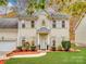 Two-story house with beige siding, shutters, and a landscaped lawn at 216 Devon Forest Dr, Mooresville, NC 28115