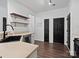 Modern kitchen with black sink, gold shelves, and dark hardwood floors at 216 Devon Forest Dr, Mooresville, NC 28115