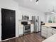 Modern kitchen with stainless steel appliances and white cabinets at 216 Devon Forest Dr, Mooresville, NC 28115