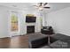 Living room with a fireplace and comfortable gray seating at 216 Devon Forest Dr, Mooresville, NC 28115