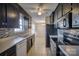 Galley kitchen with dark cabinets and tile backsplash at 2306 6Th Nw Ave, Hickory, NC 28601